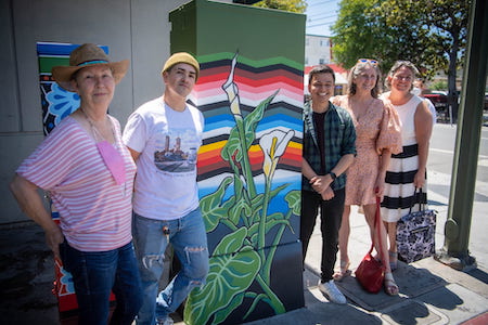 art box with painting and 4 people smiling