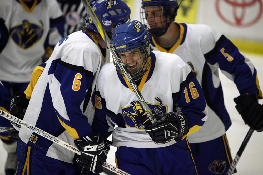 four hockey players celbrating 